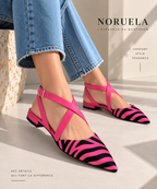 Ballerines à bout pointu imprimé zèbre roses Noruela portées avec un jean